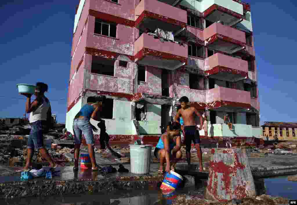 Cubanos recolectan agua hoy, viernes 7 de octubre de 2016, tras el paso hace tres días del huracán Matthew en Baracoa (Cuba).EFE/Alejandro Ernesto